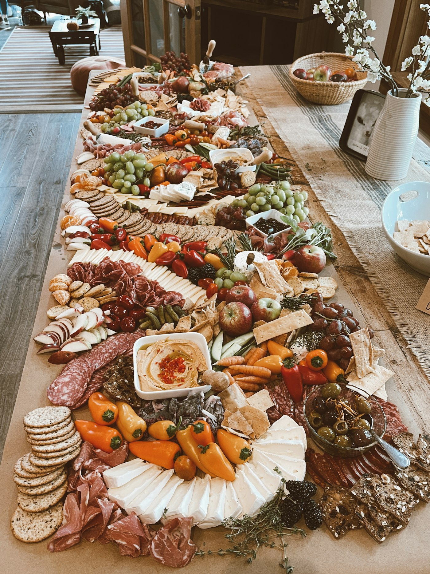 A long table laden with charcuterie and cheese